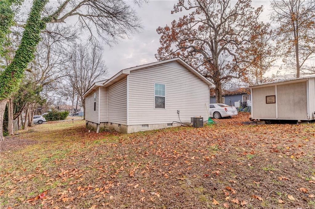 213 Iron Street Northwest Rome, GA 30165 - Photo 25 of 28 a backyard of a house with large trees and covered with wooden fence
