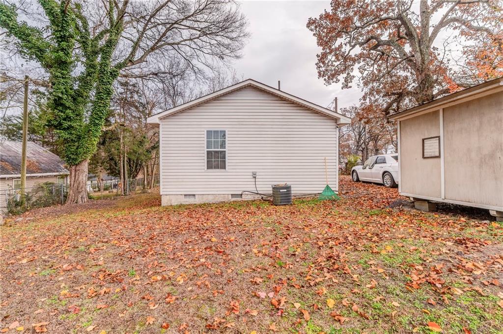 213 Iron Street Northwest Rome, GA 30165 - Photo 26 of 28 a backyard of a house with garage