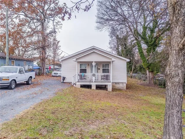 a view of a house with a yard covered in snow