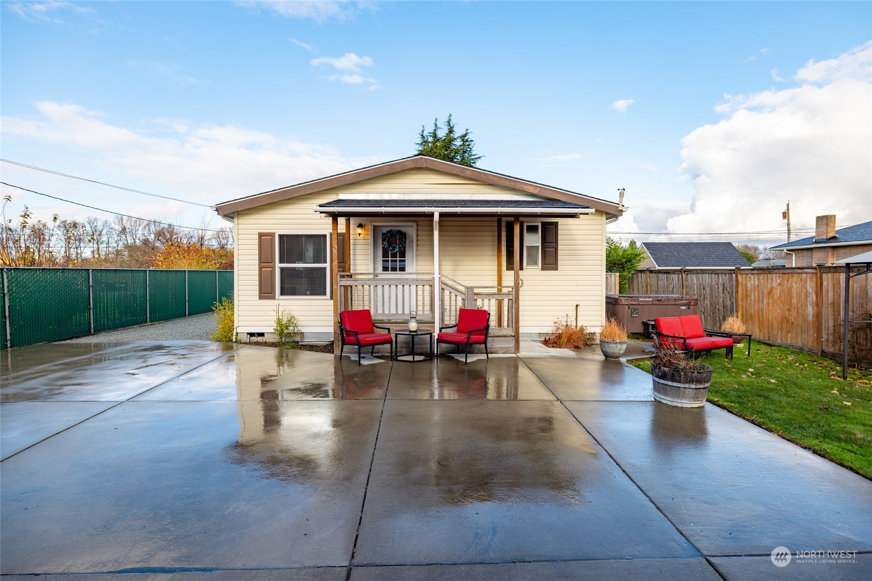 16419 Dike Road Mount Vernon, WA 98273 - Photo 7 of 39 a view of a patio with table and chairs potted plants with wooden fence