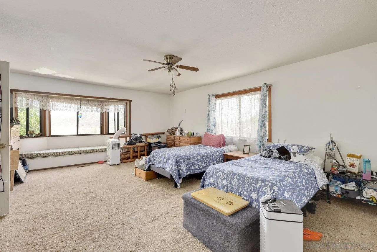 2212 Sonora Way Ramona, CA 92065 - Photo 10 of 29 a spacious bedroom with two beds and window