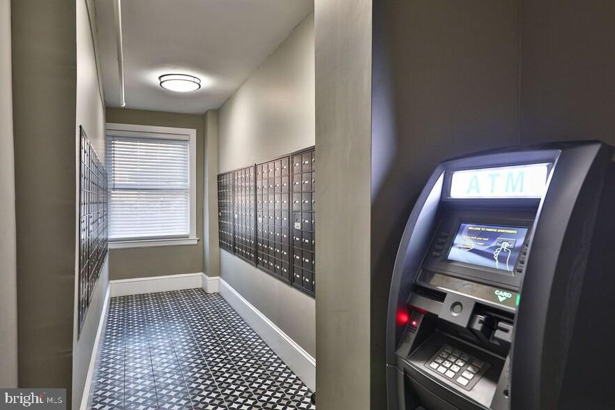 4247 Locust Street, Unit 1B621 Philadelphia, PA 19104 - Photo 35 of 38 a hallway with wooden floor washer and dryer