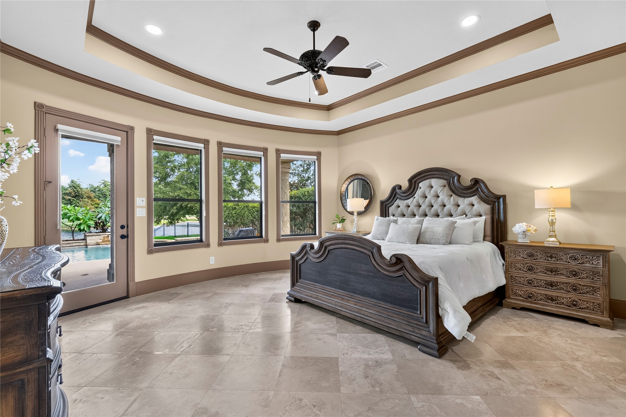 26 Post Shadow Estate Drive Spring, TX 77389 - Photo 24 of 49 The owners suite is your private oasis. Nestled away off of the foyer, this room includes a private entrance to the backyard and multiple windows for more views of the backyard and golf course.