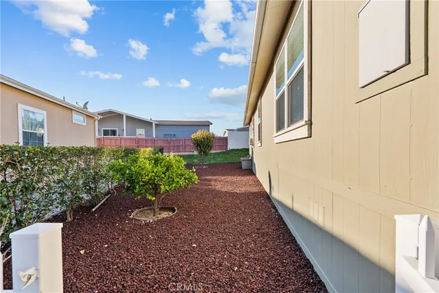 a view of a house with backyard and a tree