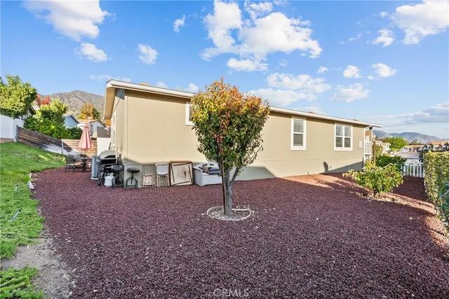 a view of a house with backyard and sitting area