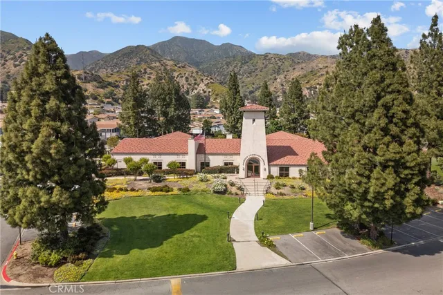 a front view of a house with a yard and lake view