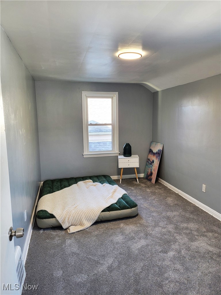 1185 Winston Road Cleveland, OH 44121 - Photo 17 of 24 Carpeted bedroom featuring vaulted ceiling