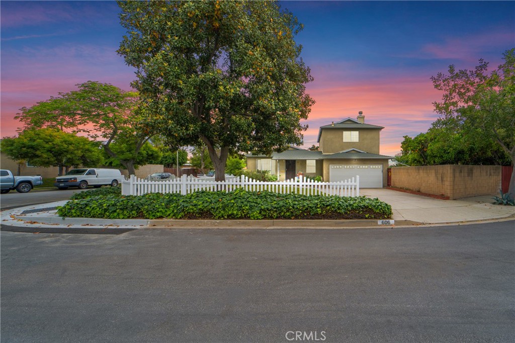 a front view of a house with a yard and a garage