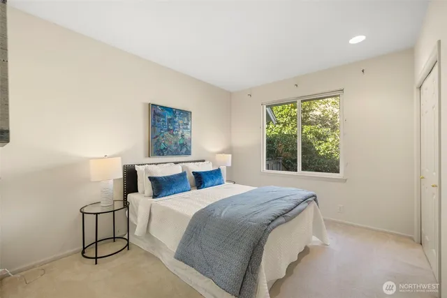 a bedroom with a bed and a painting on the wall