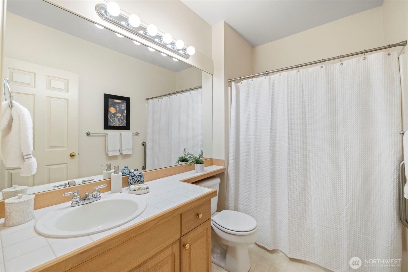 2711 204th Street Southeast Bothell, WA 98012 - Photo 19 of 22 a bathroom with a double vanity sink toilet and a mirror