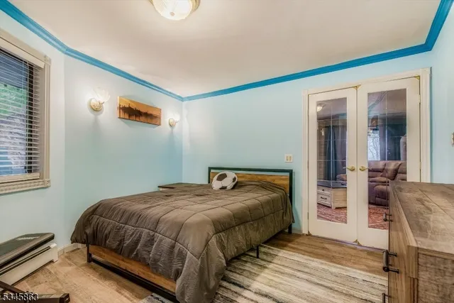 a bedroom with a bed and a chandelier