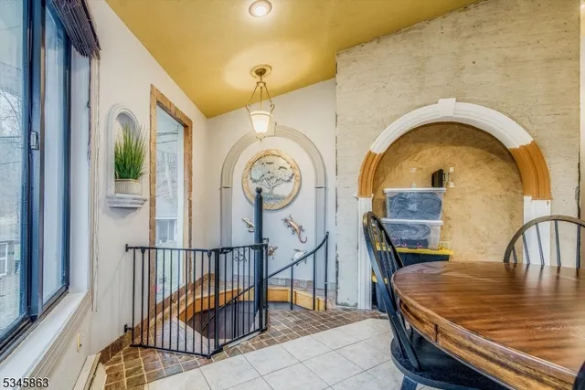 a bedroom with a bed and large windows