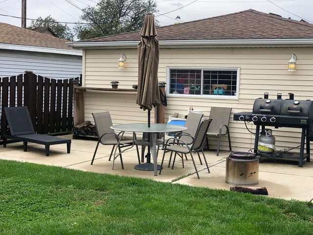a view of two chairs in a yard