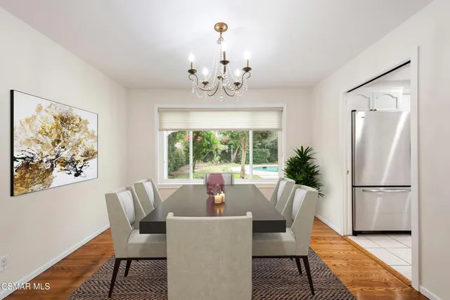 a dining room with furniture a window and a chandelier