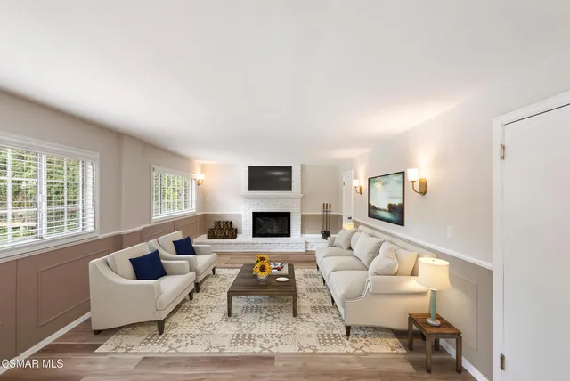 a living room with furniture a rug and a fireplace