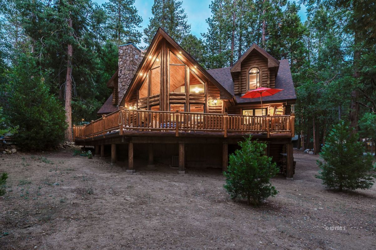 a view of a house with a yard and sitting area
