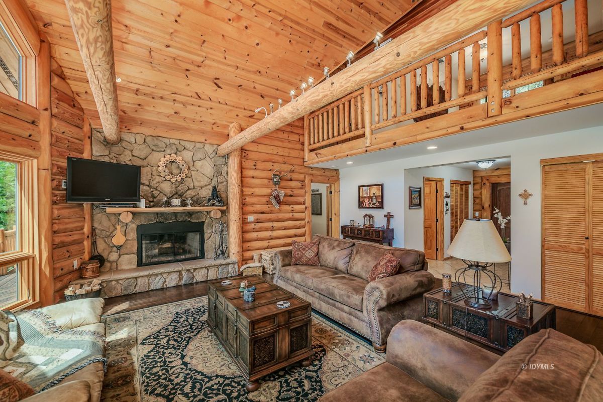 25117 Fern Valley Road Idyllwild, CA 92549 - Photo 14 of 67 a living room with furniture a flat screen tv and a fireplace