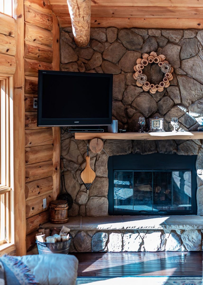 25117 Fern Valley Road Idyllwild, CA 92549 - Photo 19 of 67 a living room with fireplace furniture and a wooden floor