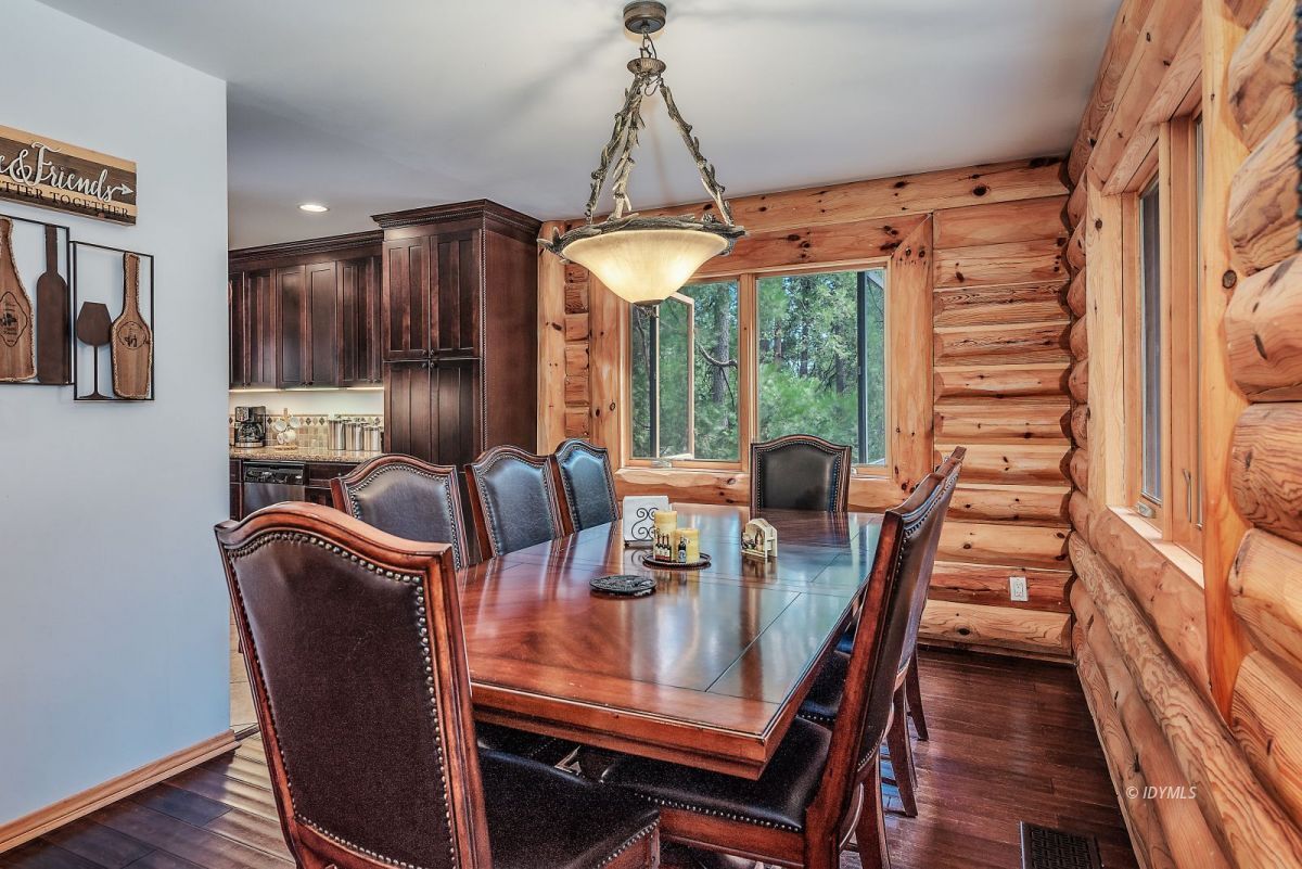 25117 Fern Valley Road Idyllwild, CA 92549 - Photo 23 of 67 a dining room with furniture a chandelier and wooden floor