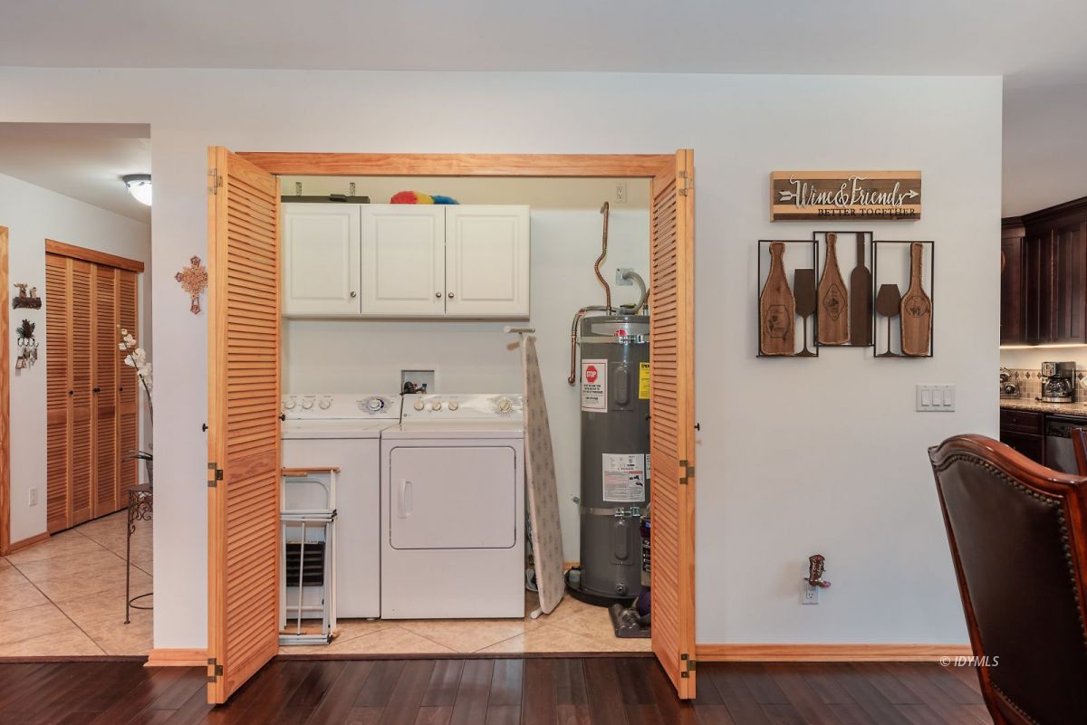 25117 Fern Valley Road Idyllwild, CA 92549 - Photo 25 of 67 a kitchen with stainless steel appliances white cabinets and wooden floor