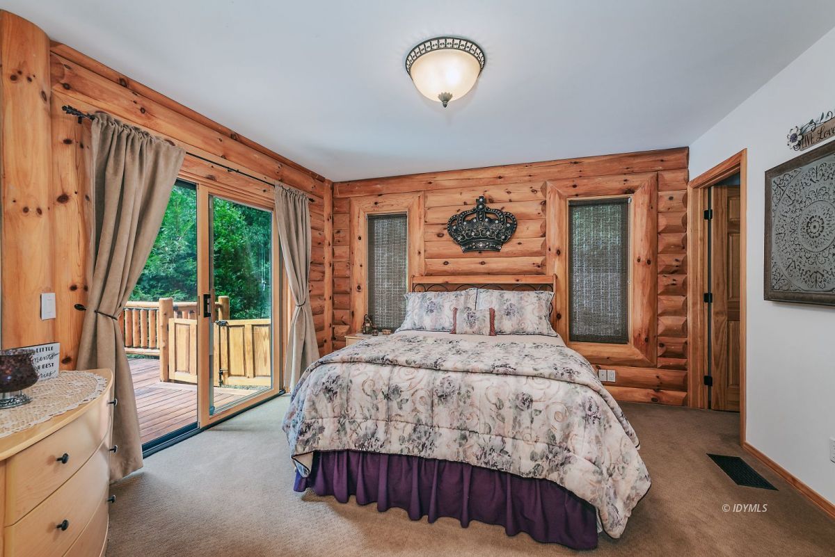 25117 Fern Valley Road Idyllwild, CA 92549 - Photo 30 of 67 a bedroom with a large bed and a large window