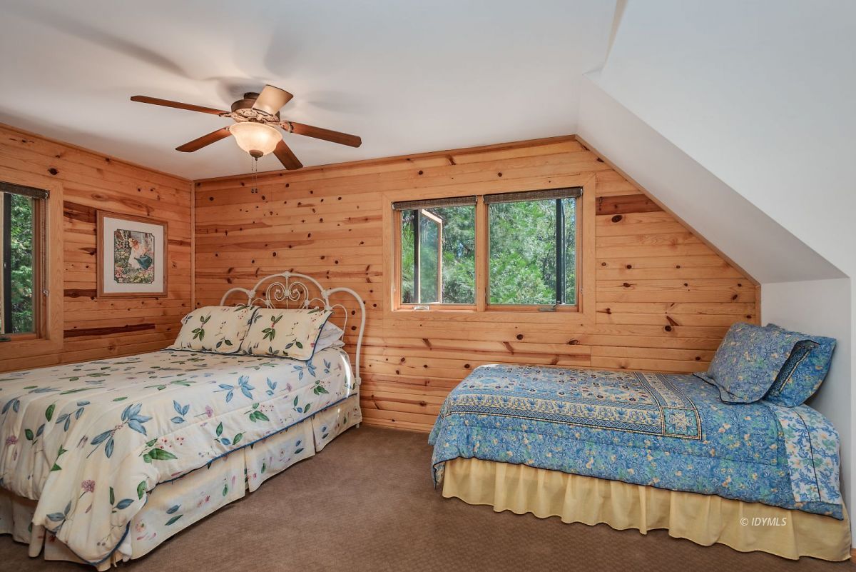 25117 Fern Valley Road Idyllwild, CA 92549 - Photo 37 of 67 a bedroom with a large bed and a window