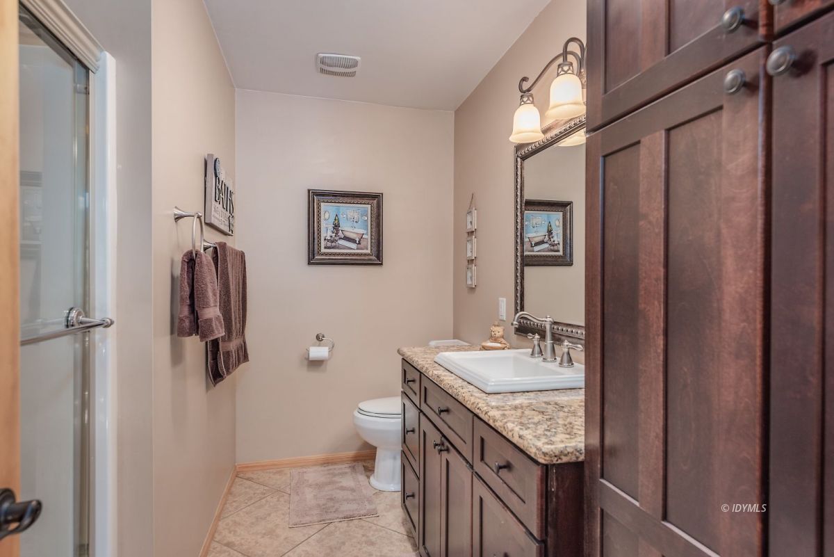 25117 Fern Valley Road Idyllwild, CA 92549 - Photo 39 of 67 a bathroom with a granite countertop sink a toilet and shower