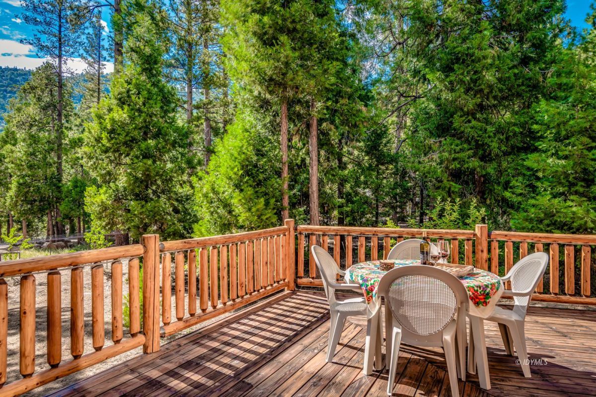 25117 Fern Valley Road Idyllwild, CA 92549 - Photo 49 of 67 a view of a chairs and table on the deck