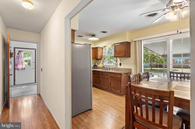 a kitchen with kitchen island granite countertop a refrigerator and a sink