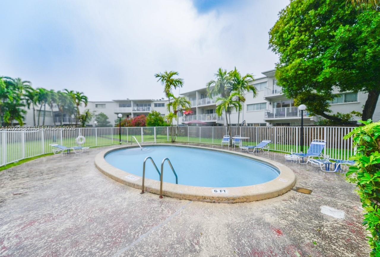 7737 Southwest 88th Street, Unit C312 Miami, FL 33156 - Photo 30 of 32 a view of a swimming pool with a patio and plants