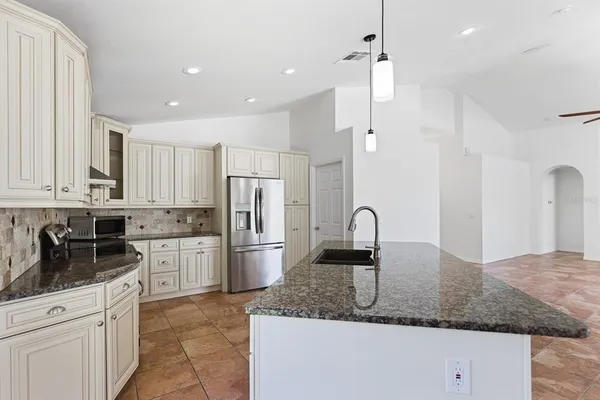 a kitchen with a sink stove and window
