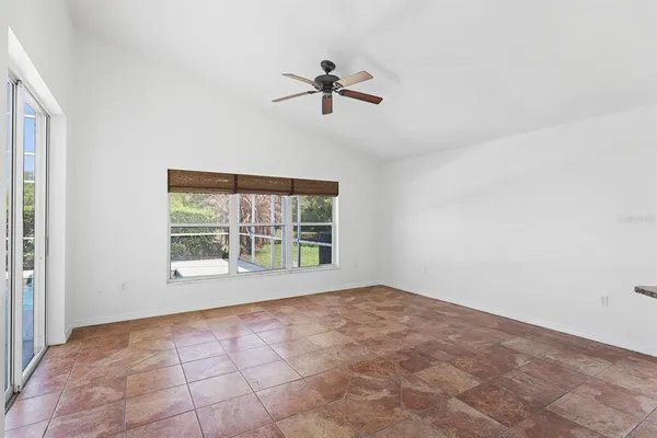 a bedroom with a balcony a bed and a painting on the wall