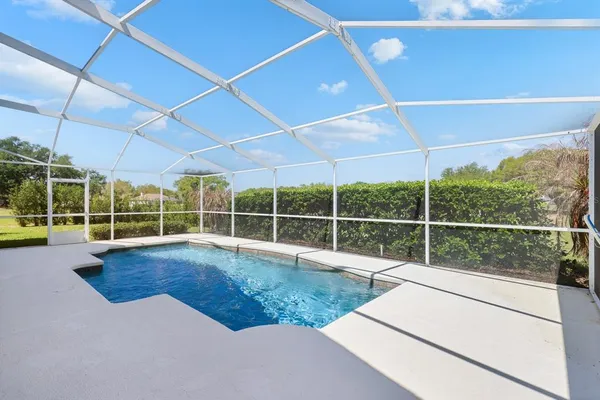 a view of a garden with house in the background