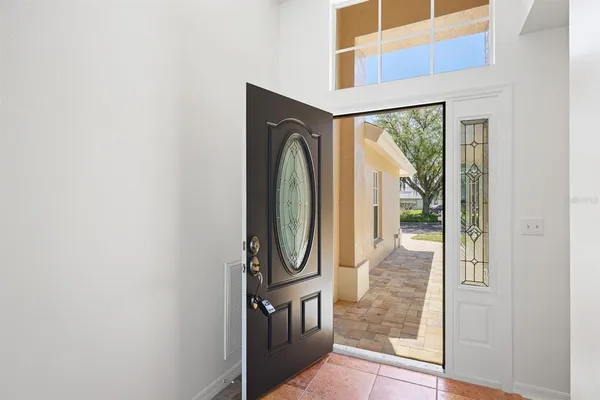 a view of a kitchen with a sink and a refrigerator