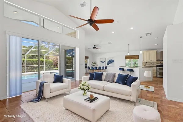 a view of a room with a ceiling fan and window
