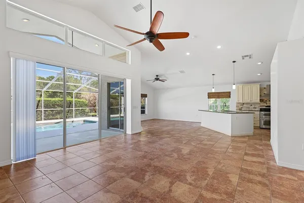 a view of a kitchen with stainless steel appliances granite countertop a refrigerator a sink and a stove
