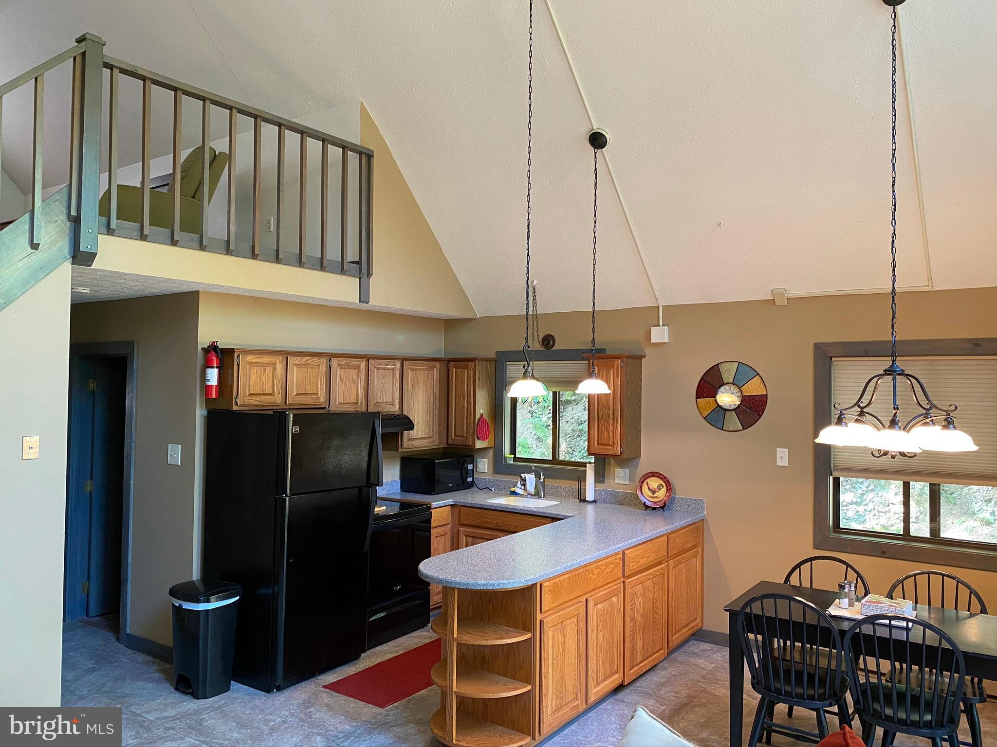 267 Susan Road Basye, VA 22842 - Photo 13 of 84 a kitchen with stainless steel appliances kitchen island granite countertop a refrigerator a stove and a sink with granite countertops