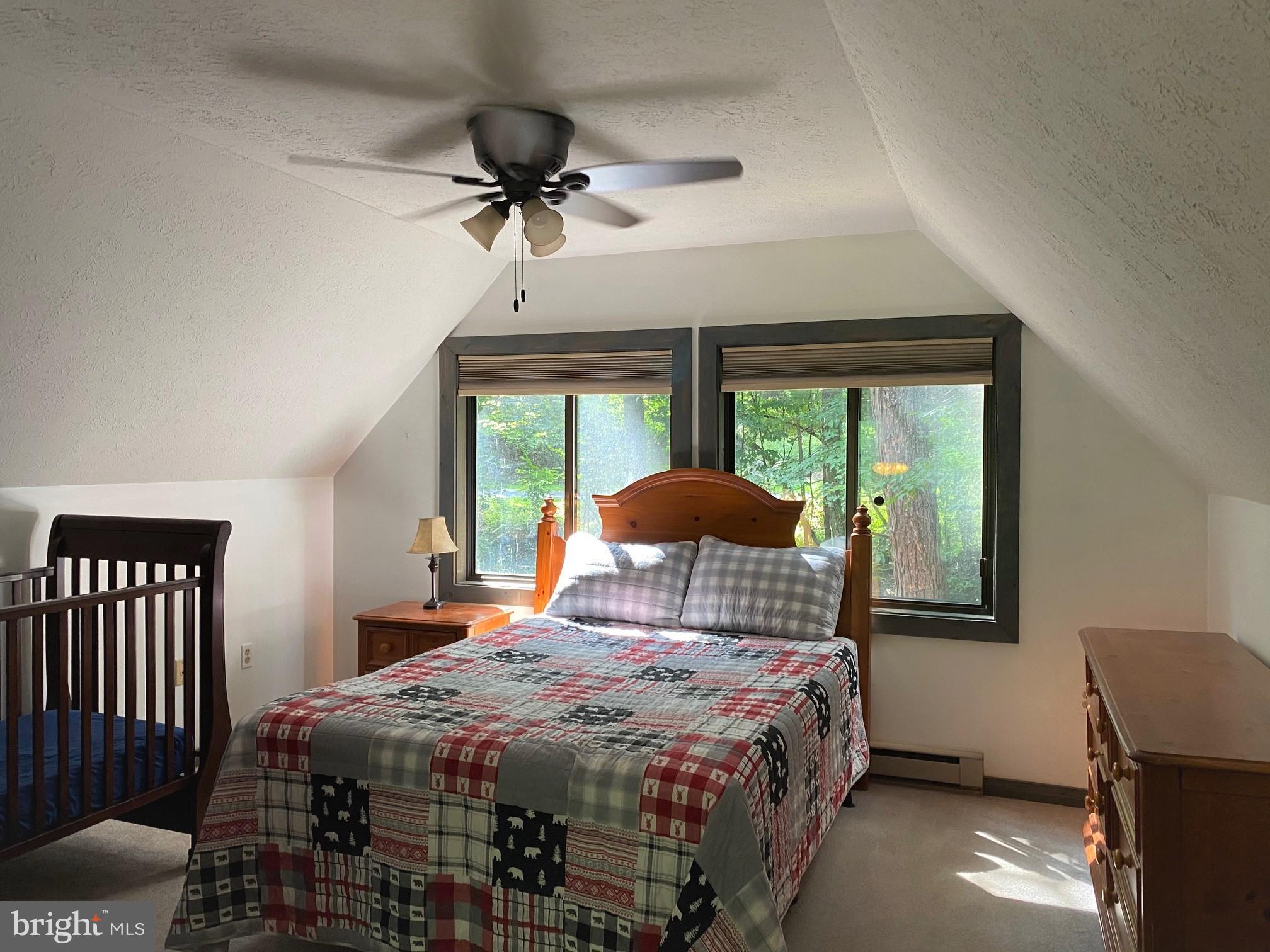 267 Susan Road Basye, VA 22842 - Photo 27 of 84 a bedroom with a bed and a chandelier