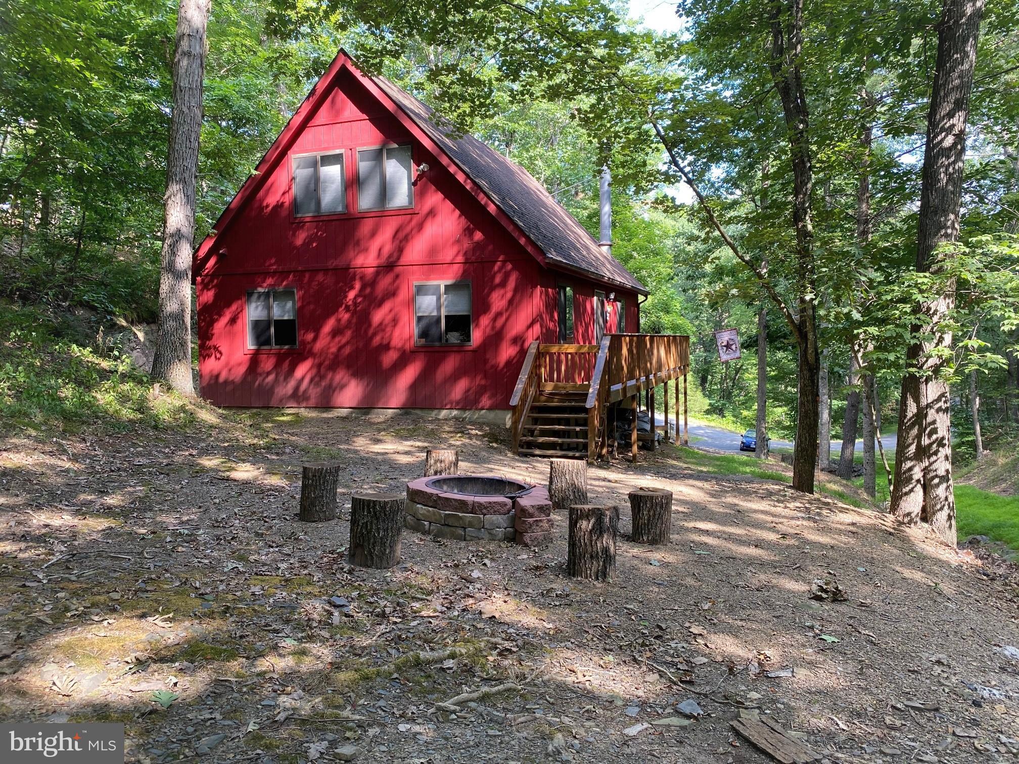 267 Susan Road Basye, VA 22842 - Photo 37 of 84 a view of backyard with table and chairs a fire pit and large trees