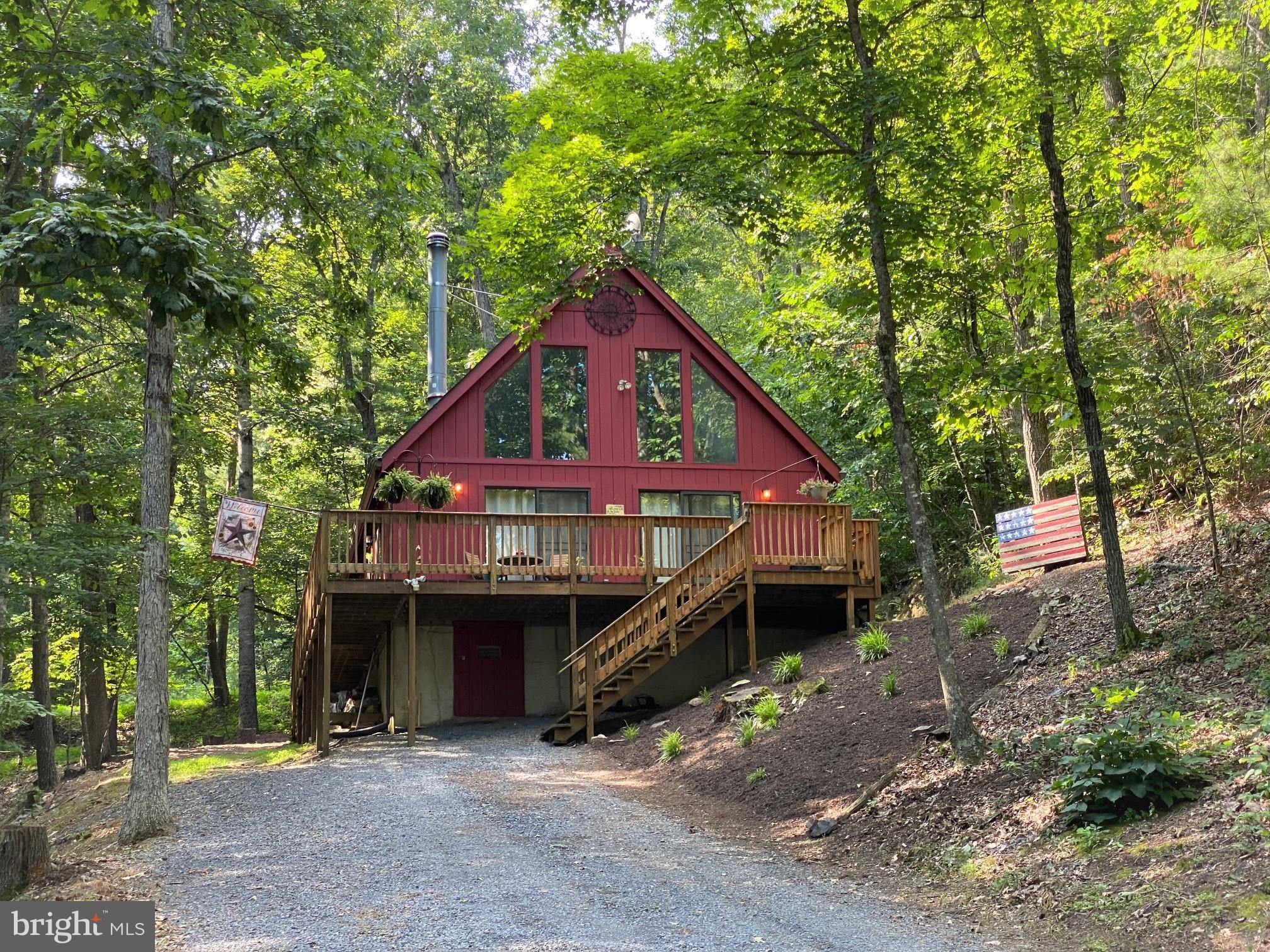 267 Susan Road Basye, VA 22842 - Photo 38 of 84 a view of a house next to a yard with large trees