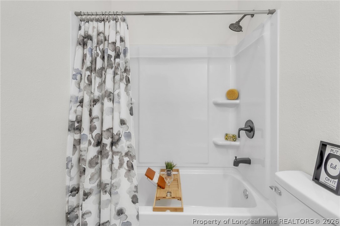 203 Trinity Street Fairmont, NC 28340 - Photo 28 of 34 a bathroom with a sink and a shower curtain
