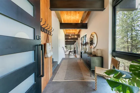 a view of entryway and hall with wooden floor