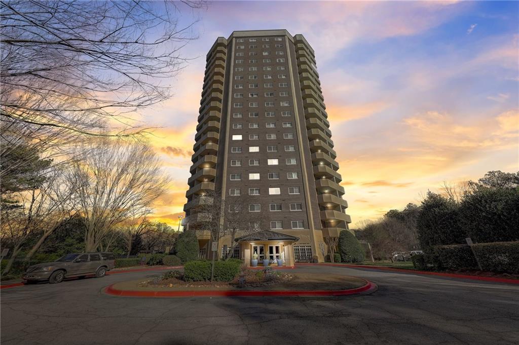a view of a tall building next to a road