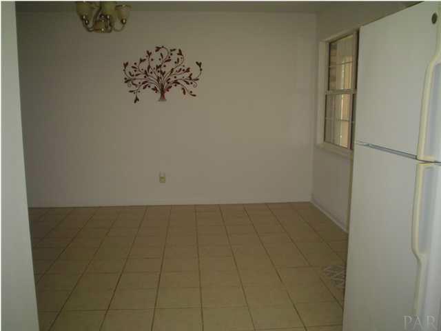 4521 Creighton Road Pensacola, FL 32504 - Photo 4 of 24 Large dining room is spacious enough to hold a formal dining set.
