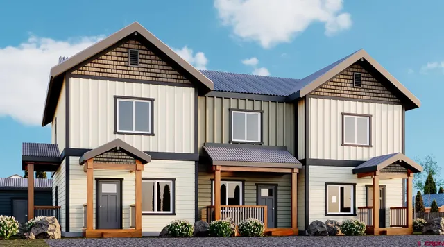 a front view of a residential houses with yard