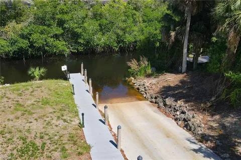 a view of a lake with a yard and trees