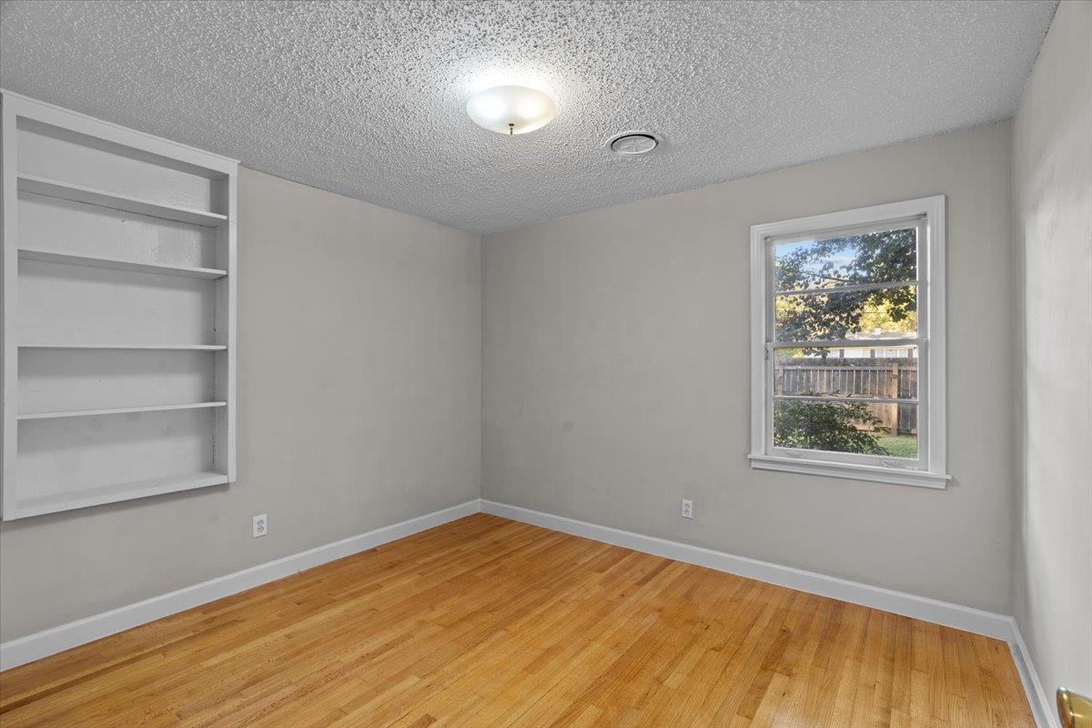 1495 Whitewater Road Memphis, TN 38117 - Photo 16 of 27 a view of empty room with wooden floor and fan