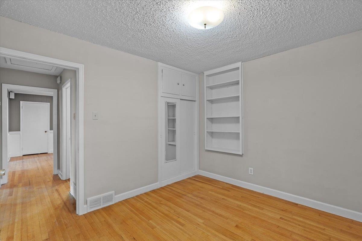 1495 Whitewater Road Memphis, TN 38117 - Photo 17 of 27 a view of empty room with wooden floor and cabinet