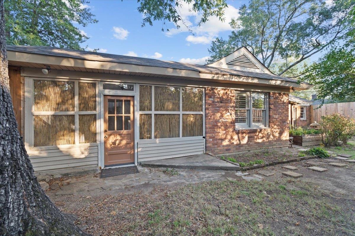 1495 Whitewater Road Memphis, TN 38117 - Photo 21 of 27 a view of a house with a large window and wooden fence