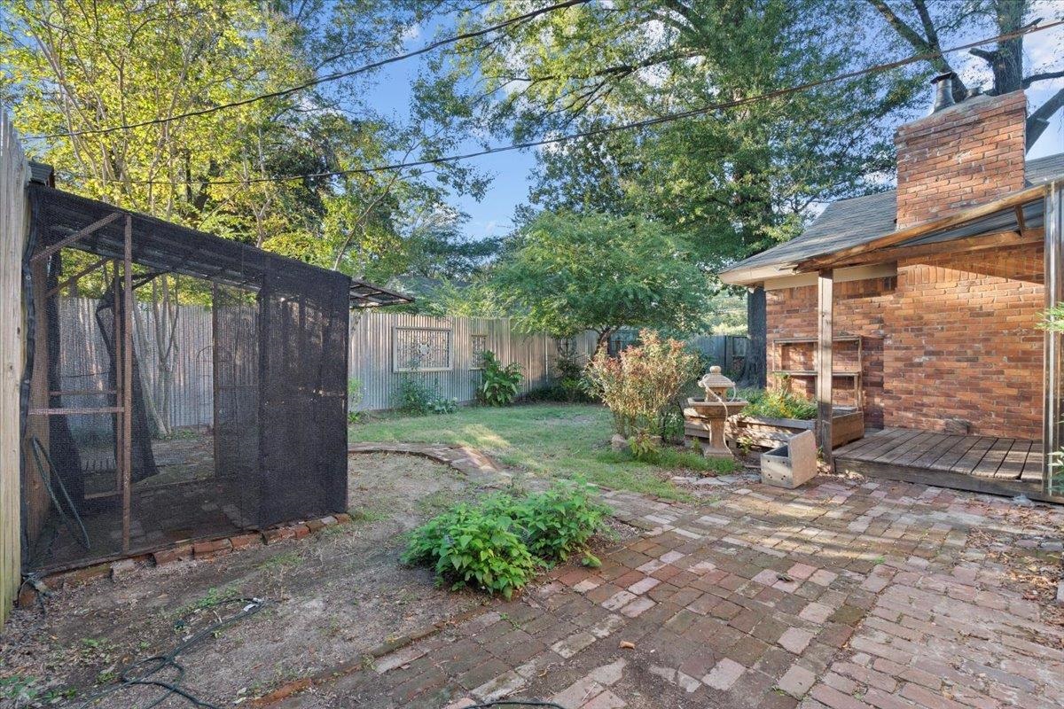 1495 Whitewater Road Memphis, TN 38117 - Photo 25 of 27 a view of a backyard with table and chairs and a barbeque